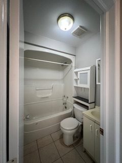 A bathroom with freshly painted grey walls around the tub and vanity