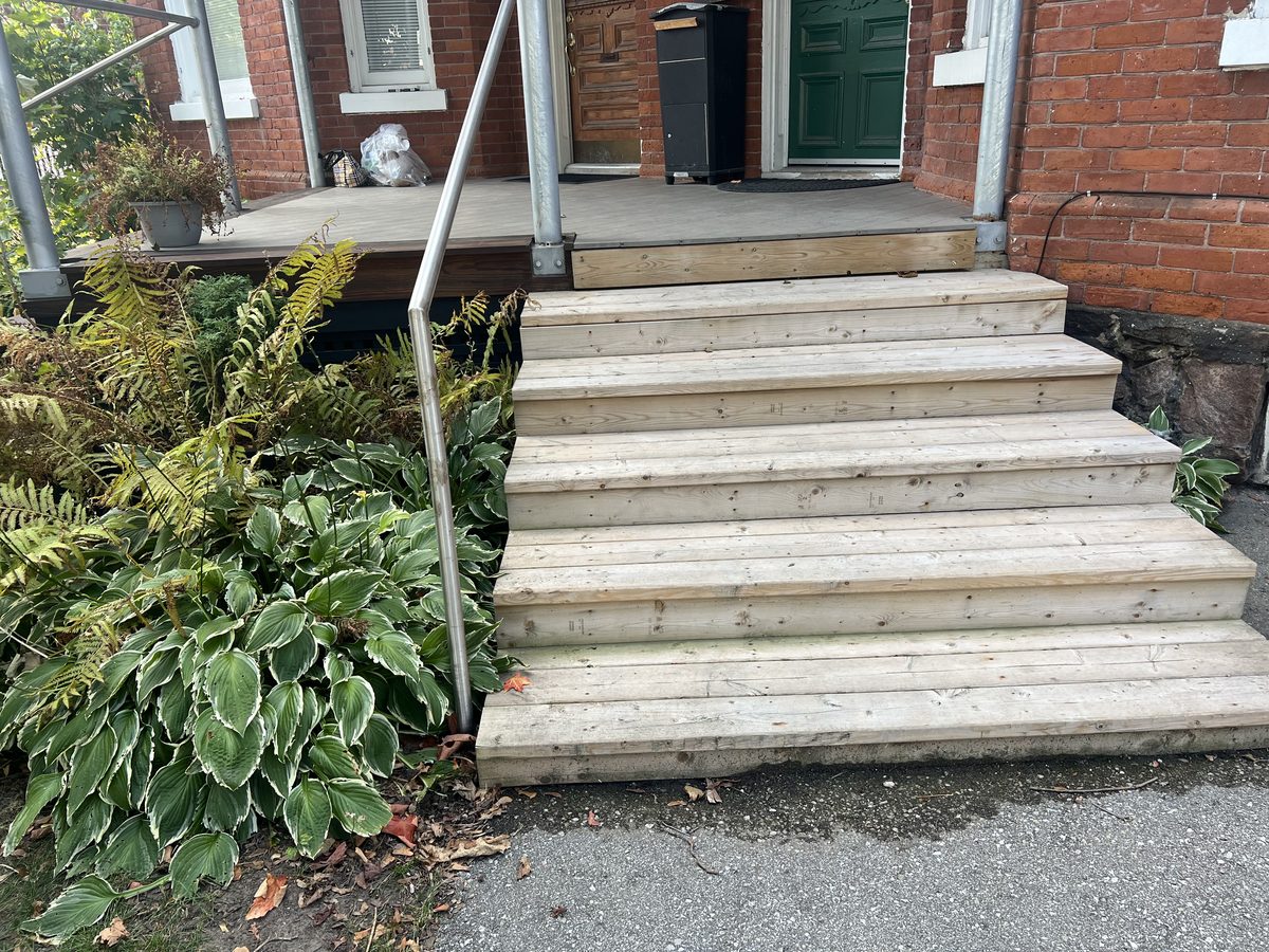 Front porch steps before staining: bare wood weathered to grey