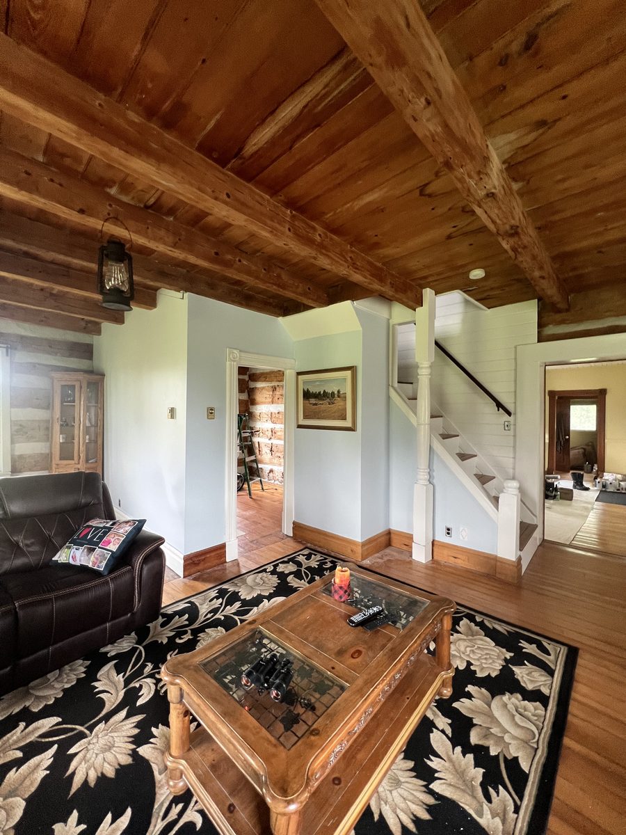 Living room with painted walls and the white staircase beyond