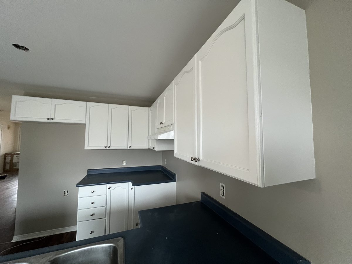 White upper cabinets and drawers along the wall